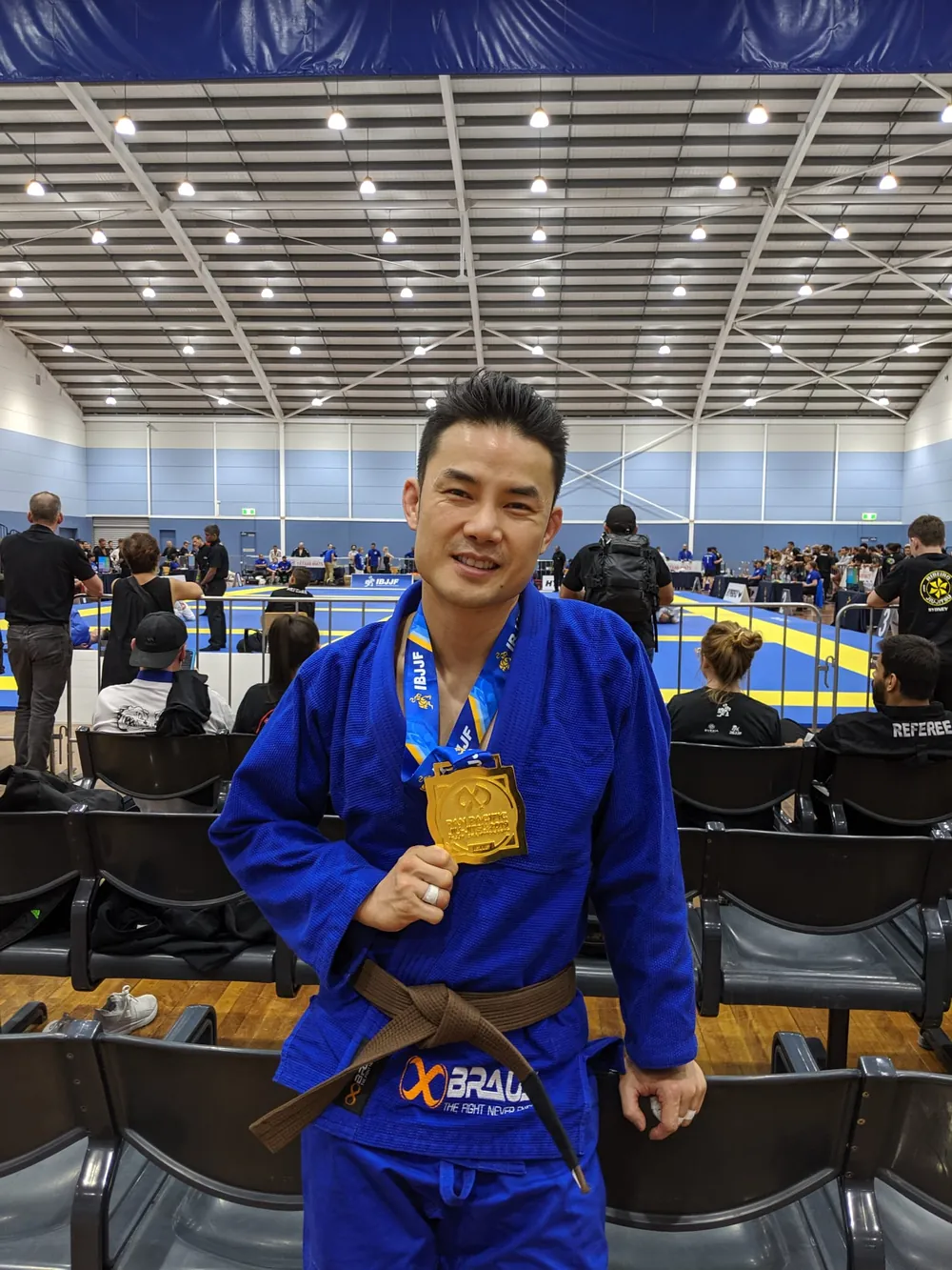 Jason Ng with a gold medal after a Brazilian Jiu Jitsu competition