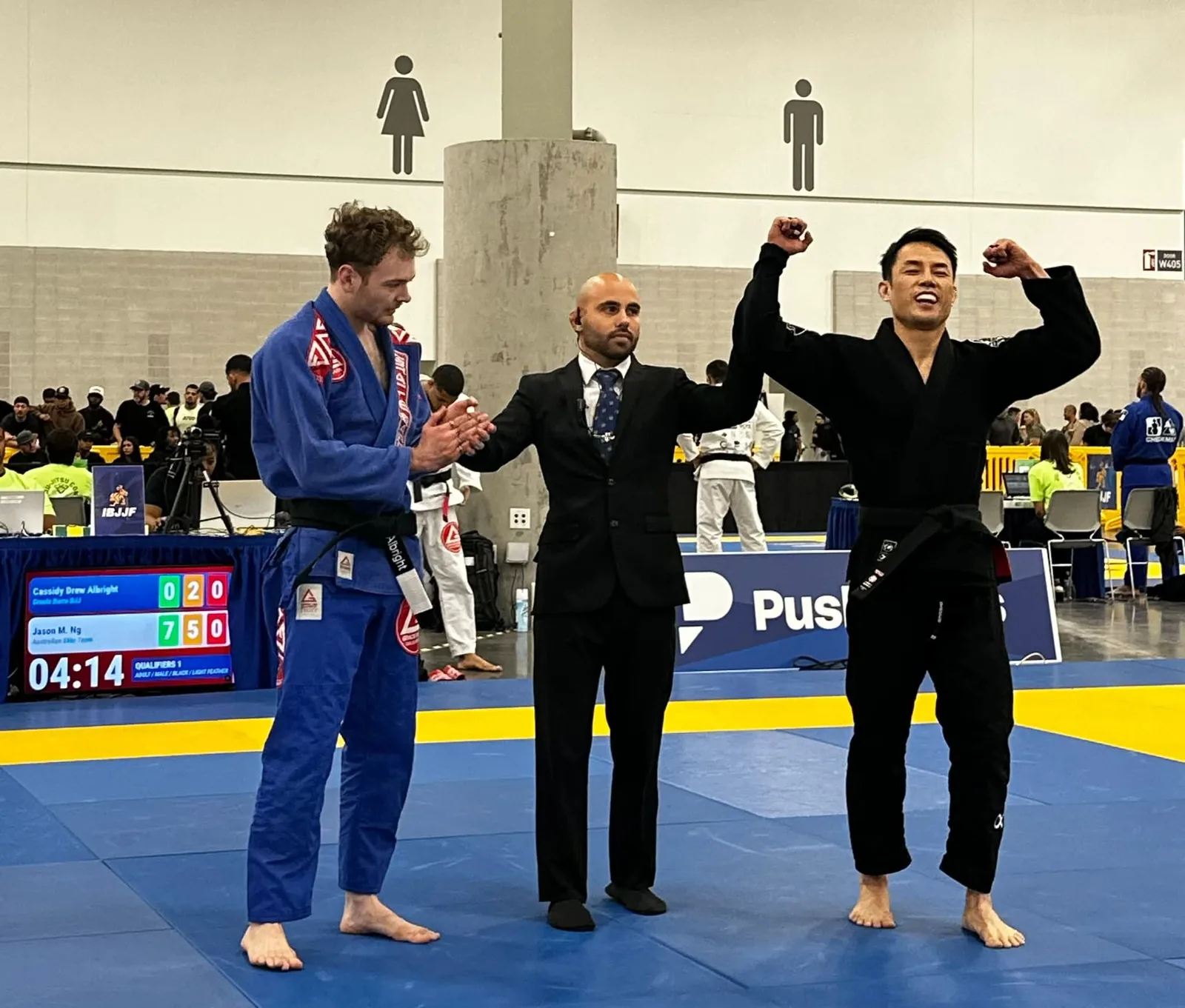 Jason Ng with his hand raised after winning a Brazilian Jiu Jitsu match